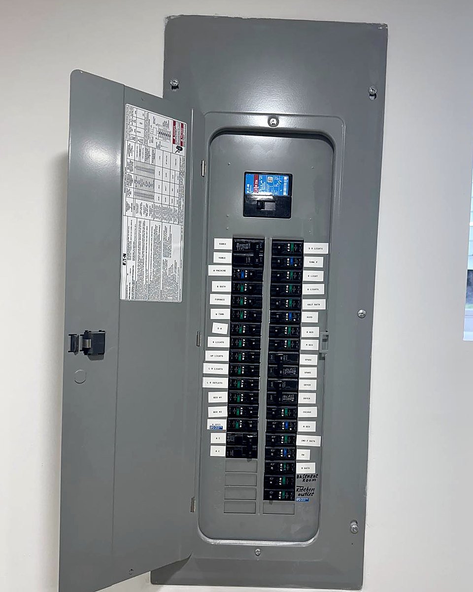 Finished residential load centre with every breaker labelled and the panel schedule filled in