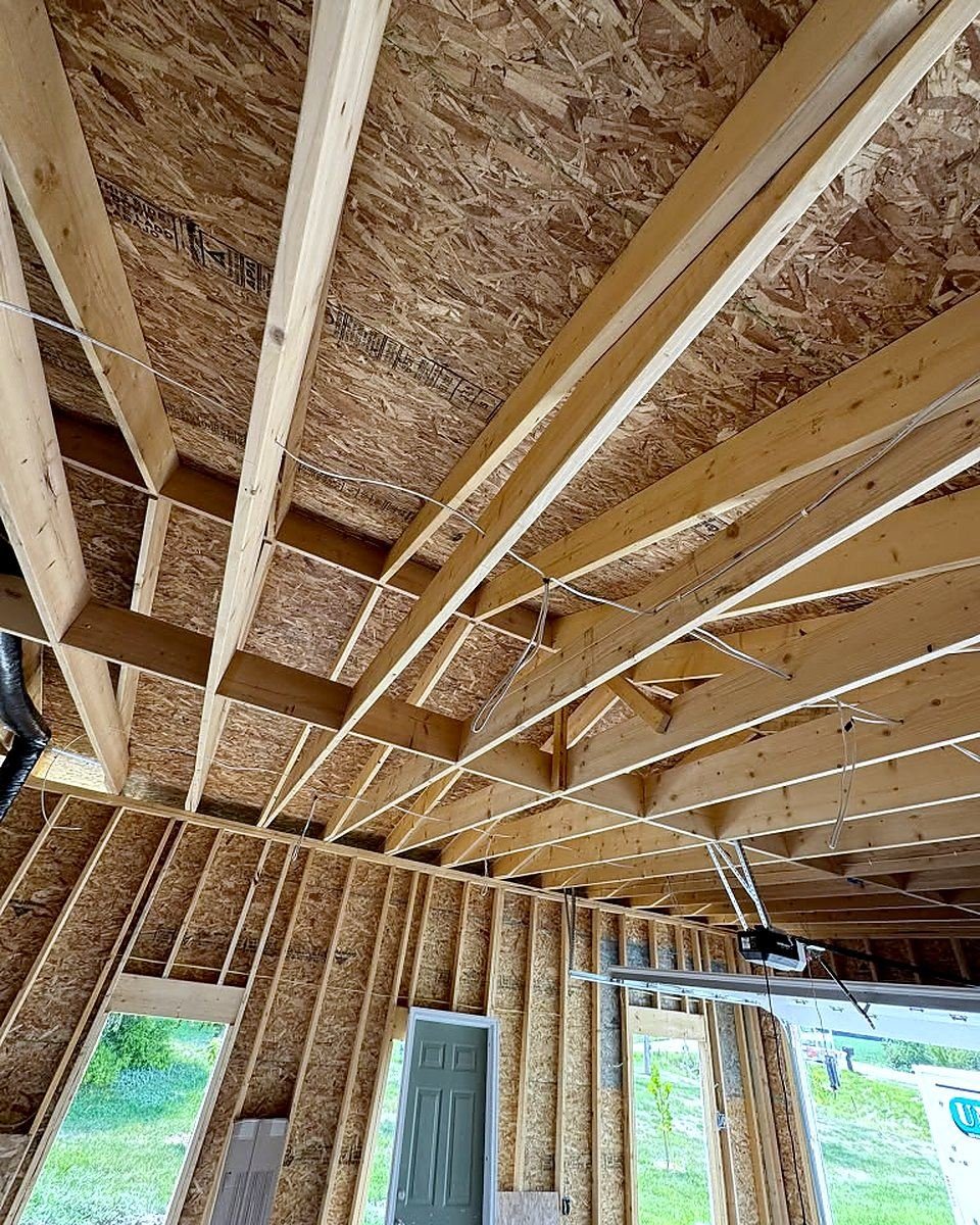 Electrical rough-in wiring run through the ceiling joists of a new garage build